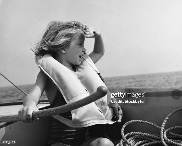 girl in sailboat, wearing life jacket, holding rudder - volcano or lava flow or salt terrace or forces of nature or forest or ocean or waves o stock pictures, royalty-free photos & images