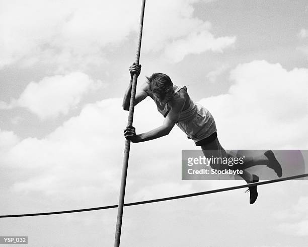 male pole-vaulter clearing bar - men's field event stock pictures, royalty-free photos & images