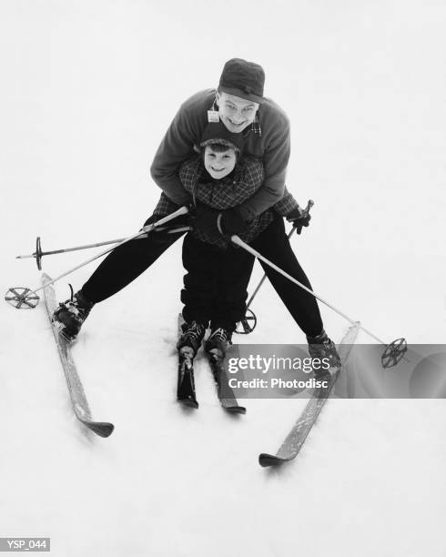 man teaching boy to ski - next to bildbanksfoton och bilder