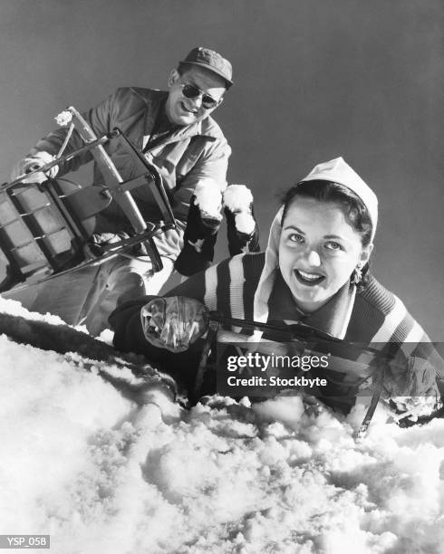 couple at top of hill, about to go sledding - the queen duke of edinburgh attend evensong in celebration of the centenary of the order of the companions of honour stockfoto's en -beelden