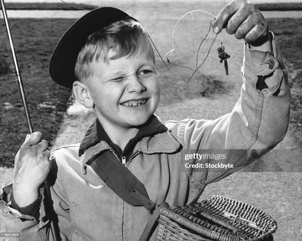 Boy squinting at baited hook