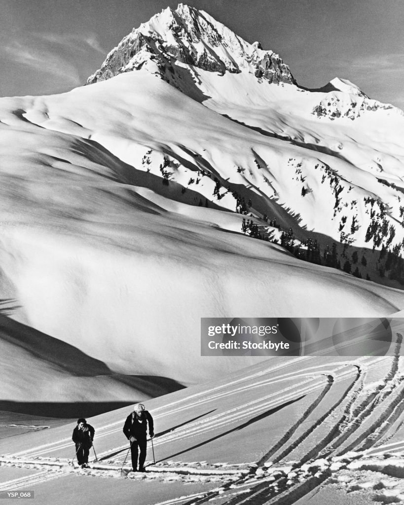 Couple cross-country skiing in mountains