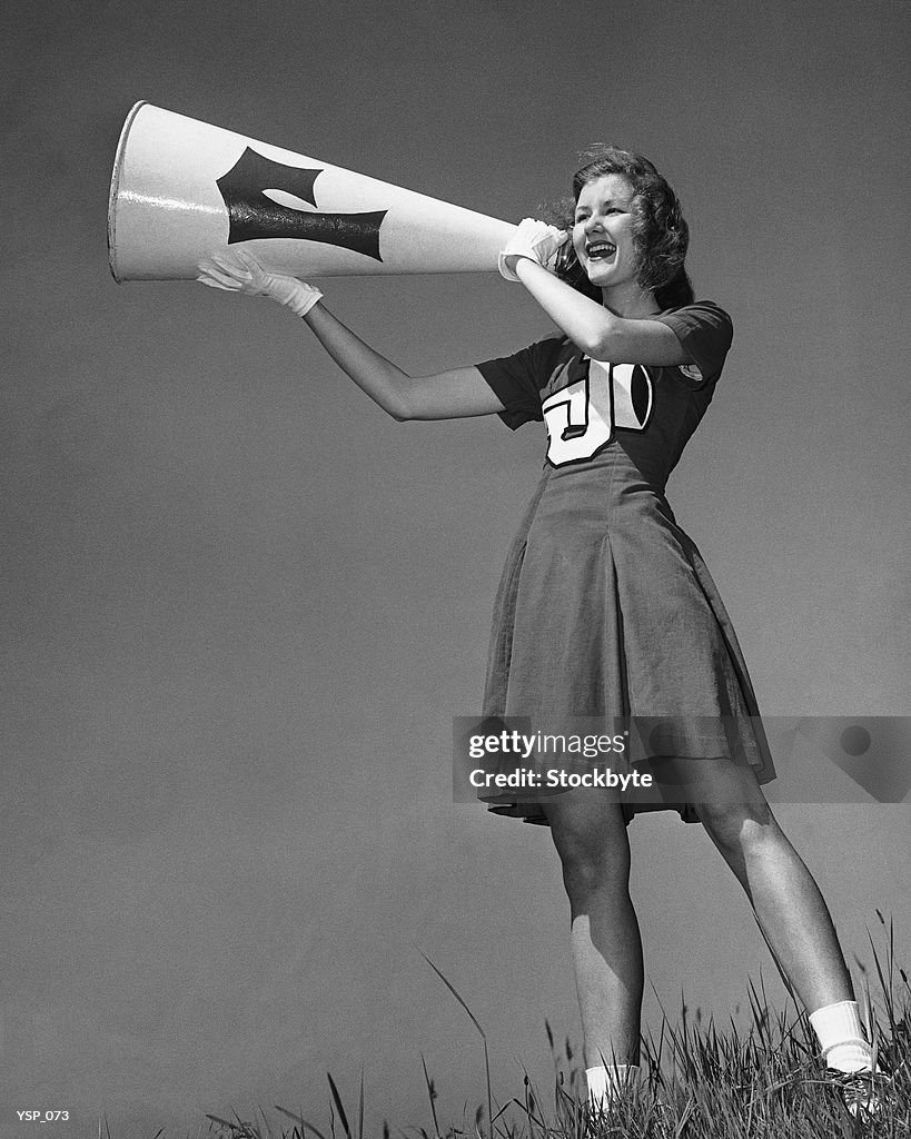 Female cheerleader using megaphone
