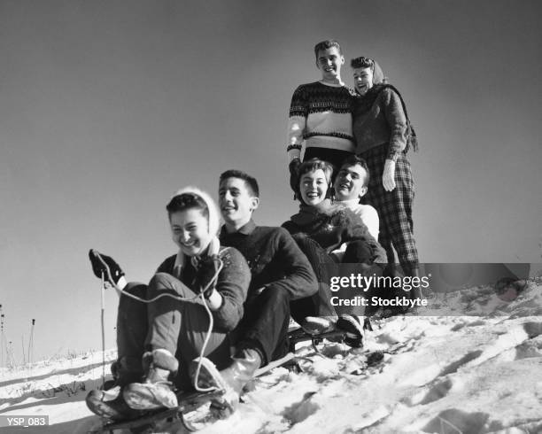 group of friends tobogganing - not looking at camera stock pictures, royalty-free photos & images