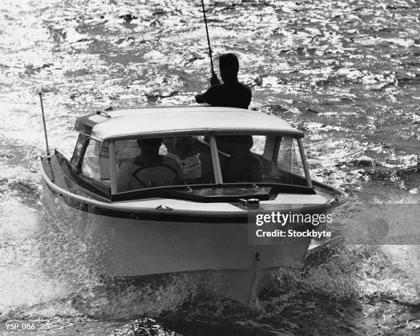 people in motorboat, one fishing - in cima - fotografias e filmes do acervo