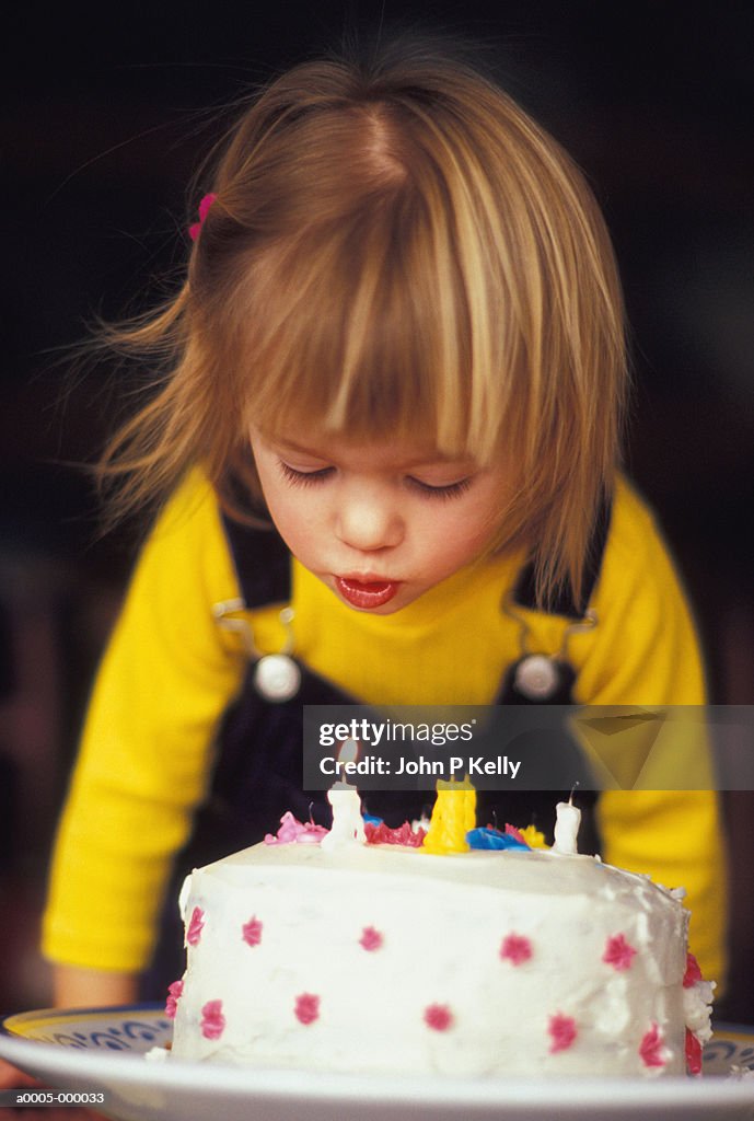 Girl Blowing Out Candles