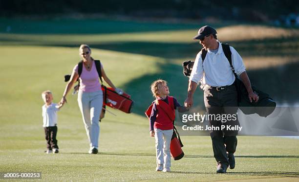 family on golf course - golf accessories stock pictures, royalty-free photos & images
