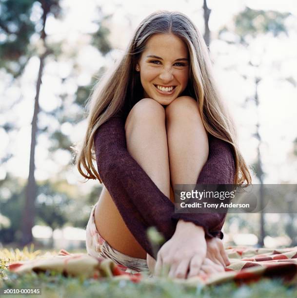 happy woman sitting on blanket - woman holding legs fotografías e imágenes de stock