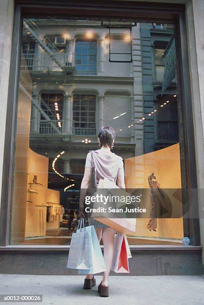 woman window shopping - clothing store stockfoto's en -beelden