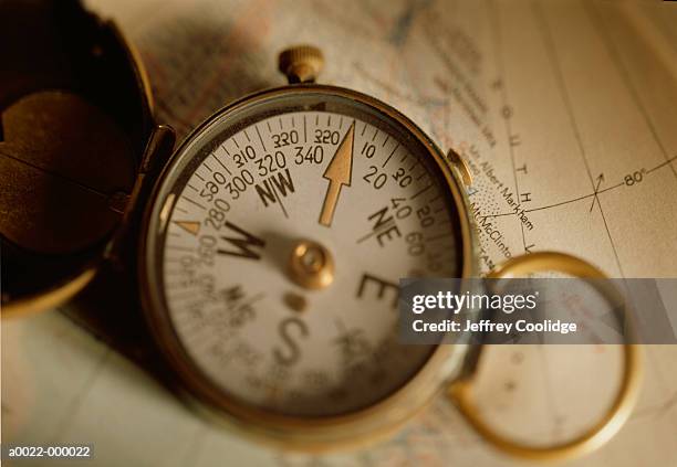 compass on map - antique compass stock pictures, royalty-free photos & images