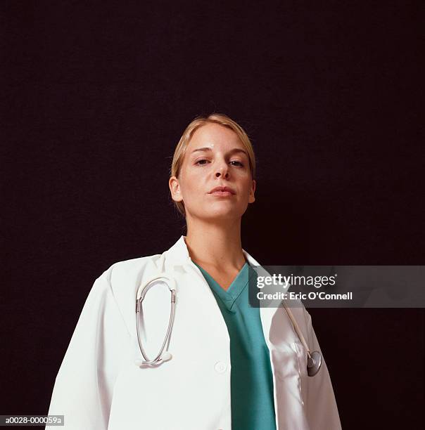 hostile looking nurse - low angle view portrait stock pictures, royalty-free photos & images