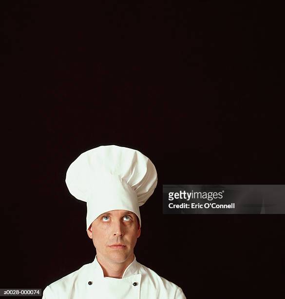 curious looking chef - toque de cuisinier photos et images de collection