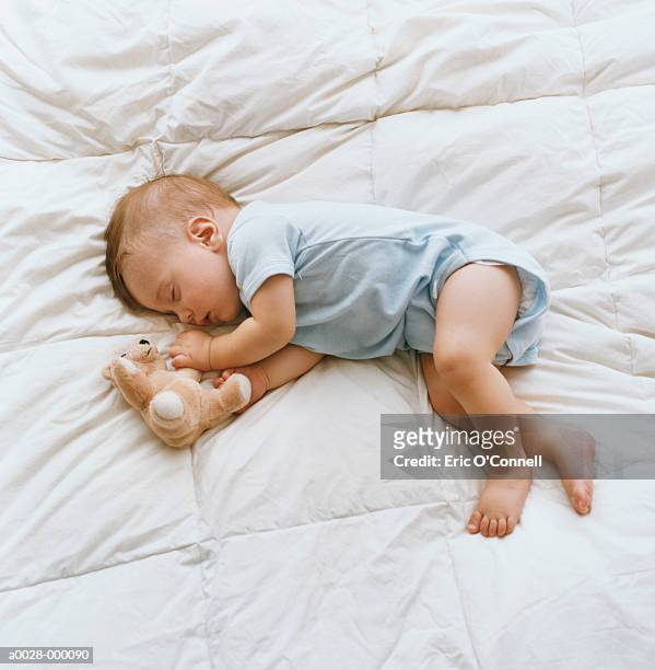 baby sleeping on bed - baby sleep stock-fotos und bilder