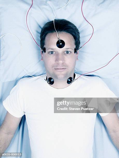 man with electrodes on head - electrode stock pictures, royalty-free photos & images