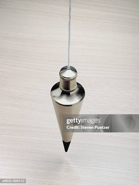 plumb weight hanging on string - the lot stock-fotos und bilder