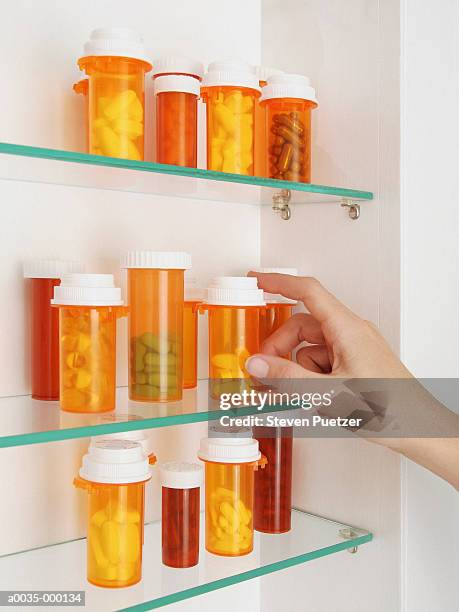 pills in medicine cabinet - medicine cabinet stock pictures, royalty-free photos & images