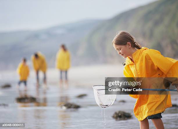 girl with fishing netvacationsfunchildhood - kagoul stock pictures, royalty-free photos & images