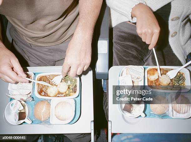 people eating airline food - airplane tray stock pictures, royalty-free photos & images
