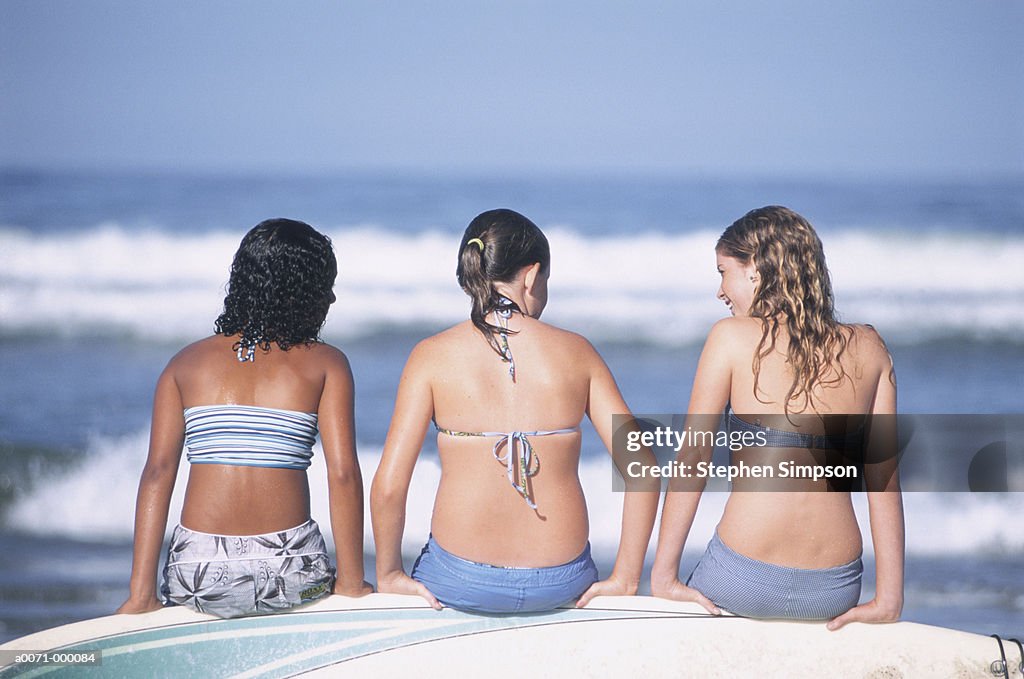 Girls Sitting on Surfboard