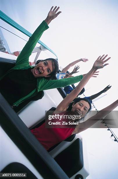 young women on rollercoaster - young woman screaming on a rollercoaster stock pictures, royalty-free photos & images