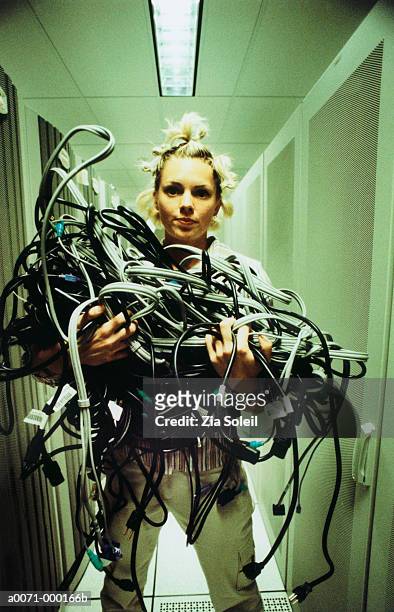 woman holding bundle of wiring - soleil humour stockfoto's en -beelden
