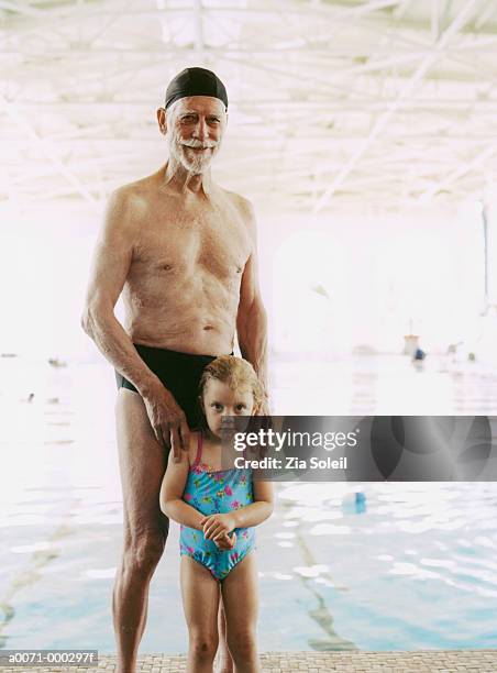 girl and grandfather by pool - maillot vert stock pictures, royalty-free photos & images