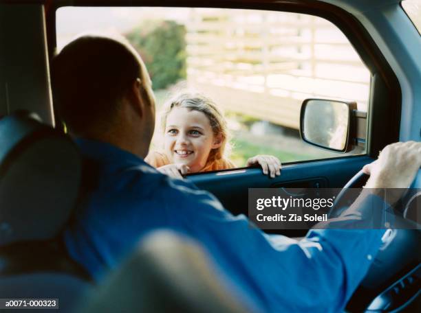 girl greeting father in car - girls driving a car stock-fotos und bilder