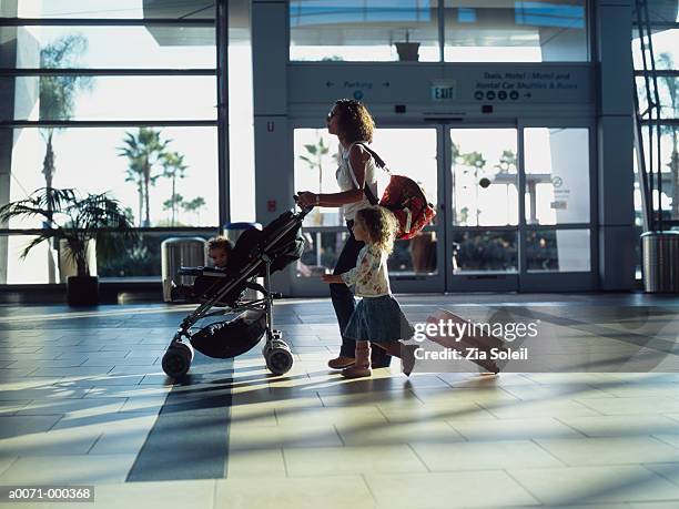 family walking through airport - baby bag bildbanksfoton och bilder