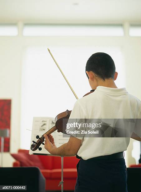 boy practicing violin - strings section stock pictures, royalty-free photos & images