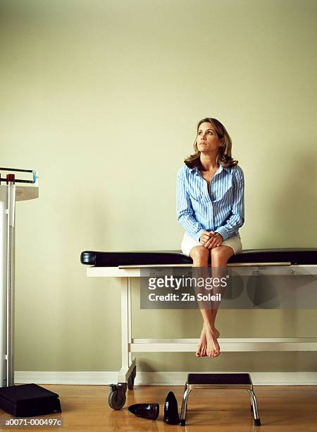 woman sitting on couch in doctor's surgery - examining table stock pictures, royalty-free photos & images