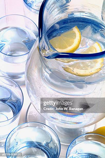 water and lemon slices in jug - jug stock pictures, royalty-free photos & images