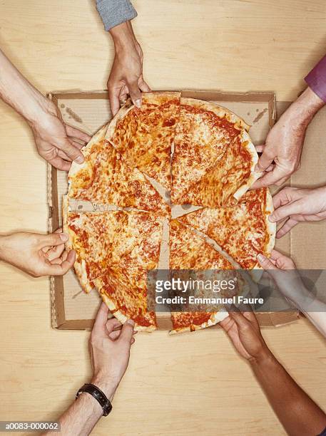 hands holding pizza slices - pizza share ストックフォトと画像