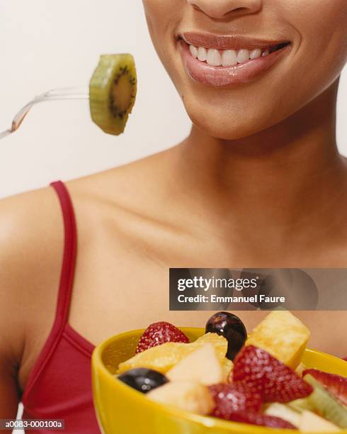 woman with fruit salad - kiwi fruit stock pictures, royalty-free photos & images