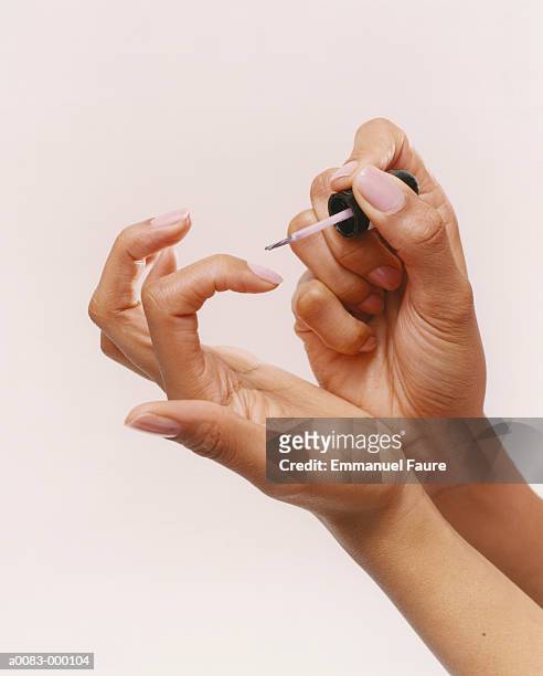 woman applying nail polish - nail polish stock pictures, royalty-free photos & images