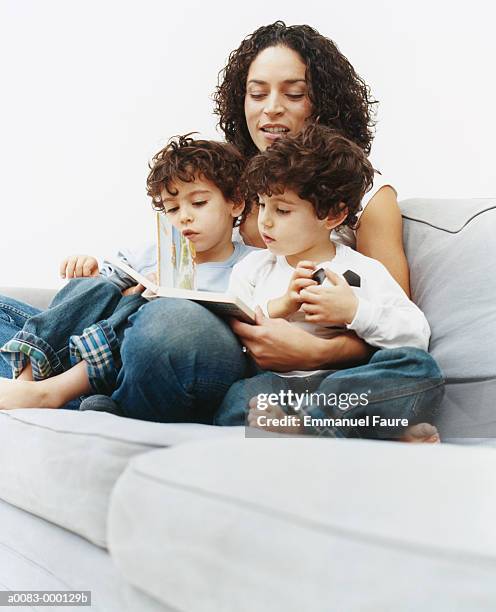 mother reading to twin boys - single mother two kids stock pictures, royalty-free photos & images