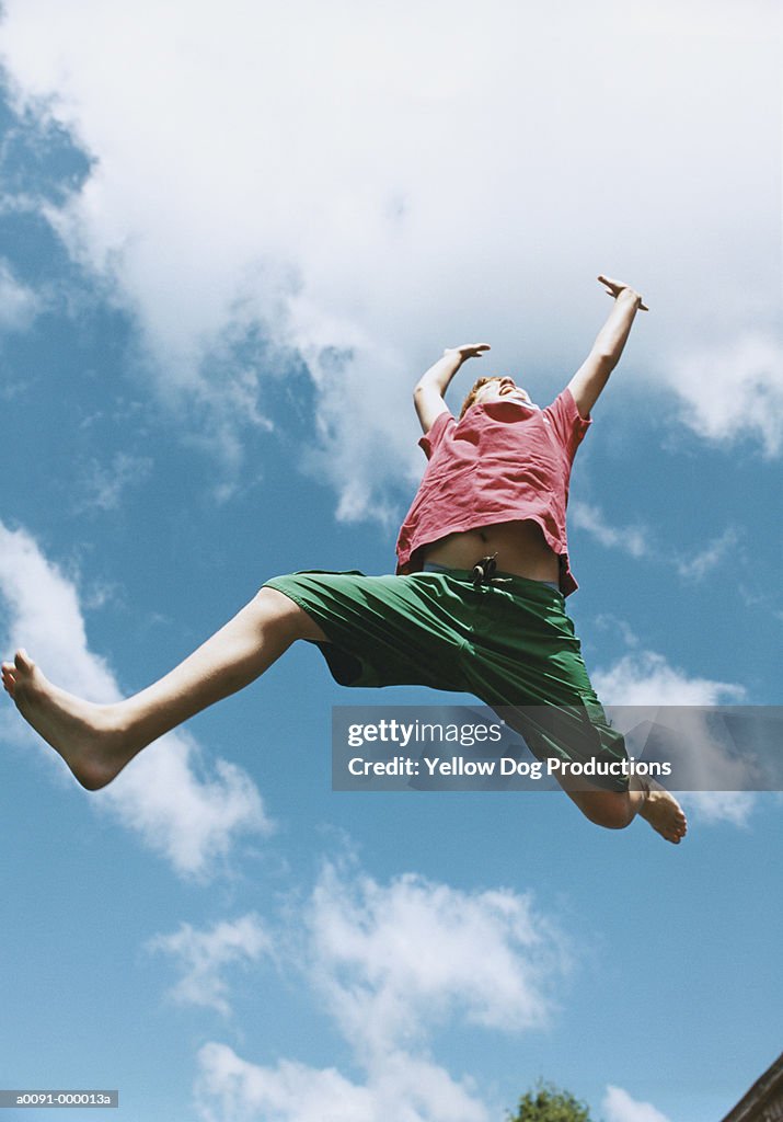 Boy Jumping in Sky