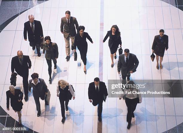 commuters walking - building atrium stock pictures, royalty-free photos & images