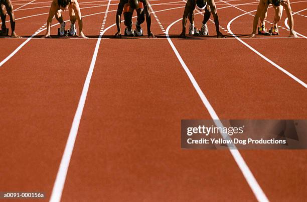 sprinters in starting blocks - restarting fotografías e imágenes de stock