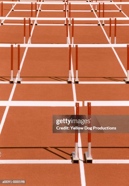 hurdles on running track - hürdenlauf stock-fotos und bilder
