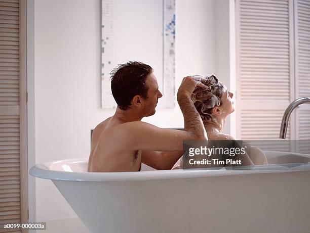 couple in bathtub - couples showering stock-fotos und bilder