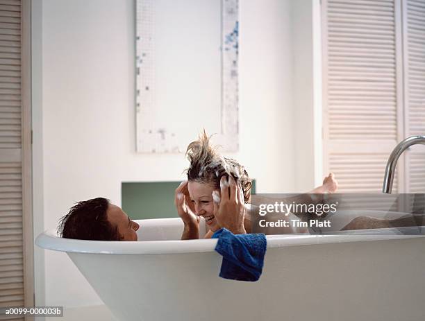 couple in bathtub - badewanne schaum stock-fotos und bilder