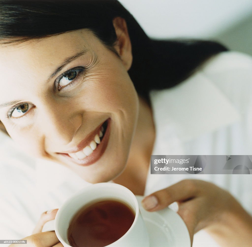 Smiling Woman with Cup of Tea