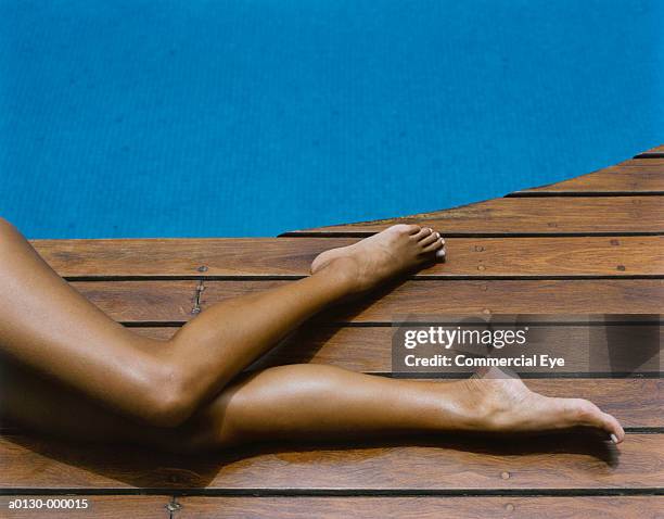 woman's legs on pool deck - womens pretty feet stock pictures, royalty-free photos & images