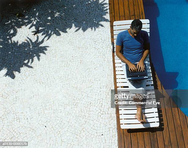 man uses laptop near pool - man in swimming pool stockfoto's en -beelden