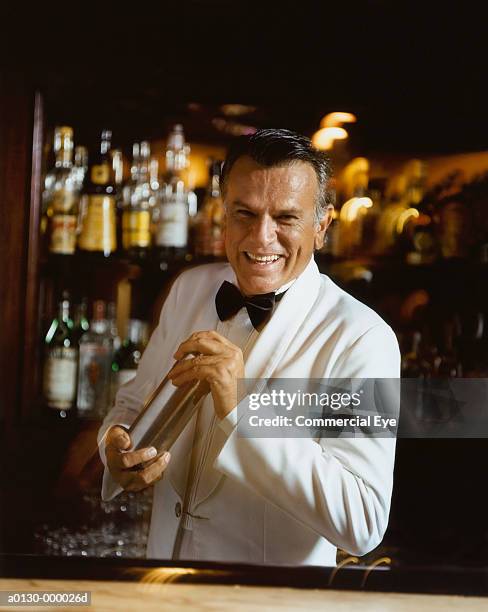 bartender making cocktail - cocktail shaker stock pictures, royalty-free photos & images