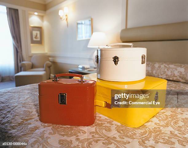 boxes with suitcase on bed - hatbox stock pictures, royalty-free photos & images