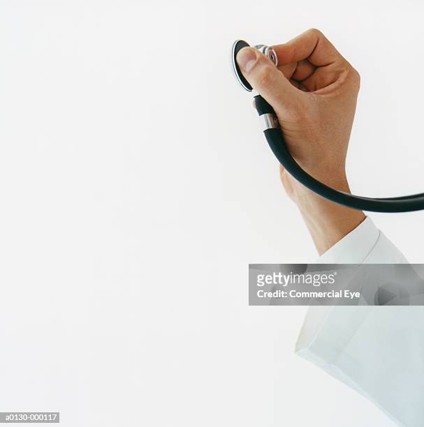 doctor's hand with stethoscope - stethoscope white background stock pictures, royalty-free photos & images