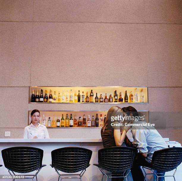 romantic couple kissing in bar - man in bar stockfoto's en -beelden