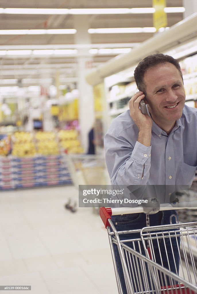 Man on Phone in Supermarket