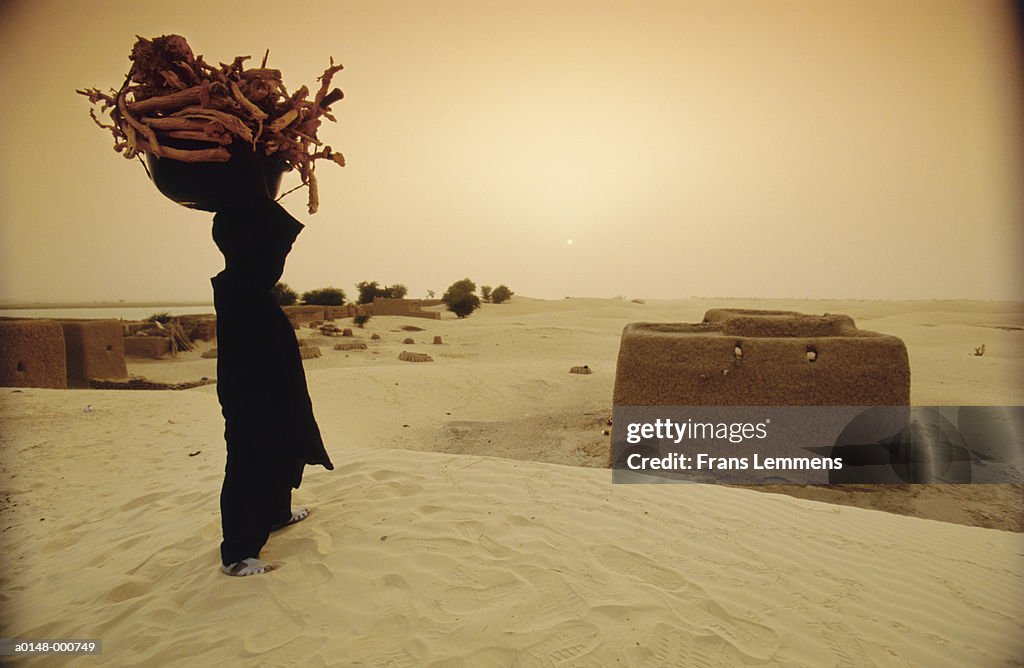 Man Carrying Firewood